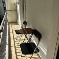 Depys Apartment 10 Sunny balcony with small table and chairs in apartment in Kavala city center.