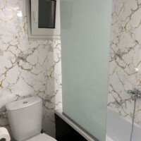 Depys Apartment 9 Modern bathroom with bathtub and marble tiles in comfortable apartment in Kavala Greece.