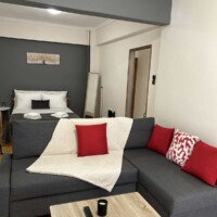 Depys Apartment 3 Bright living room with sofa and TV in modern apartment in Kavala city center.